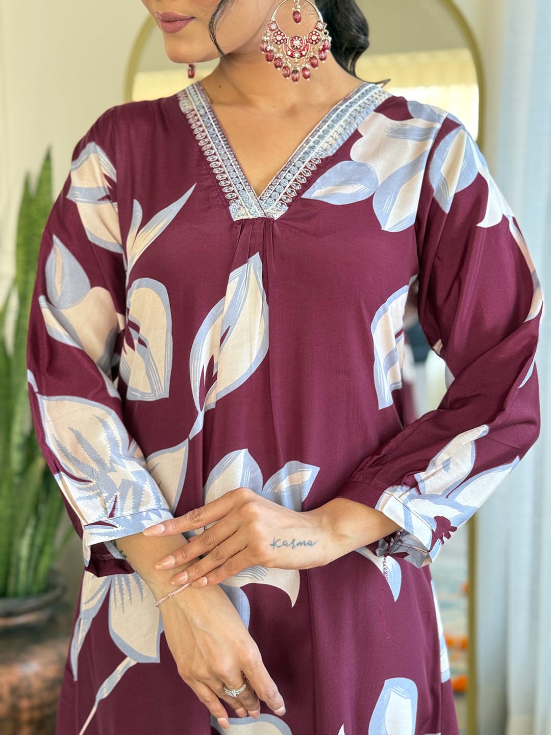 Elevate your wardrobe with this stunning maroon kurti set, adorned with bold floral prints and intricate neckline embellishments