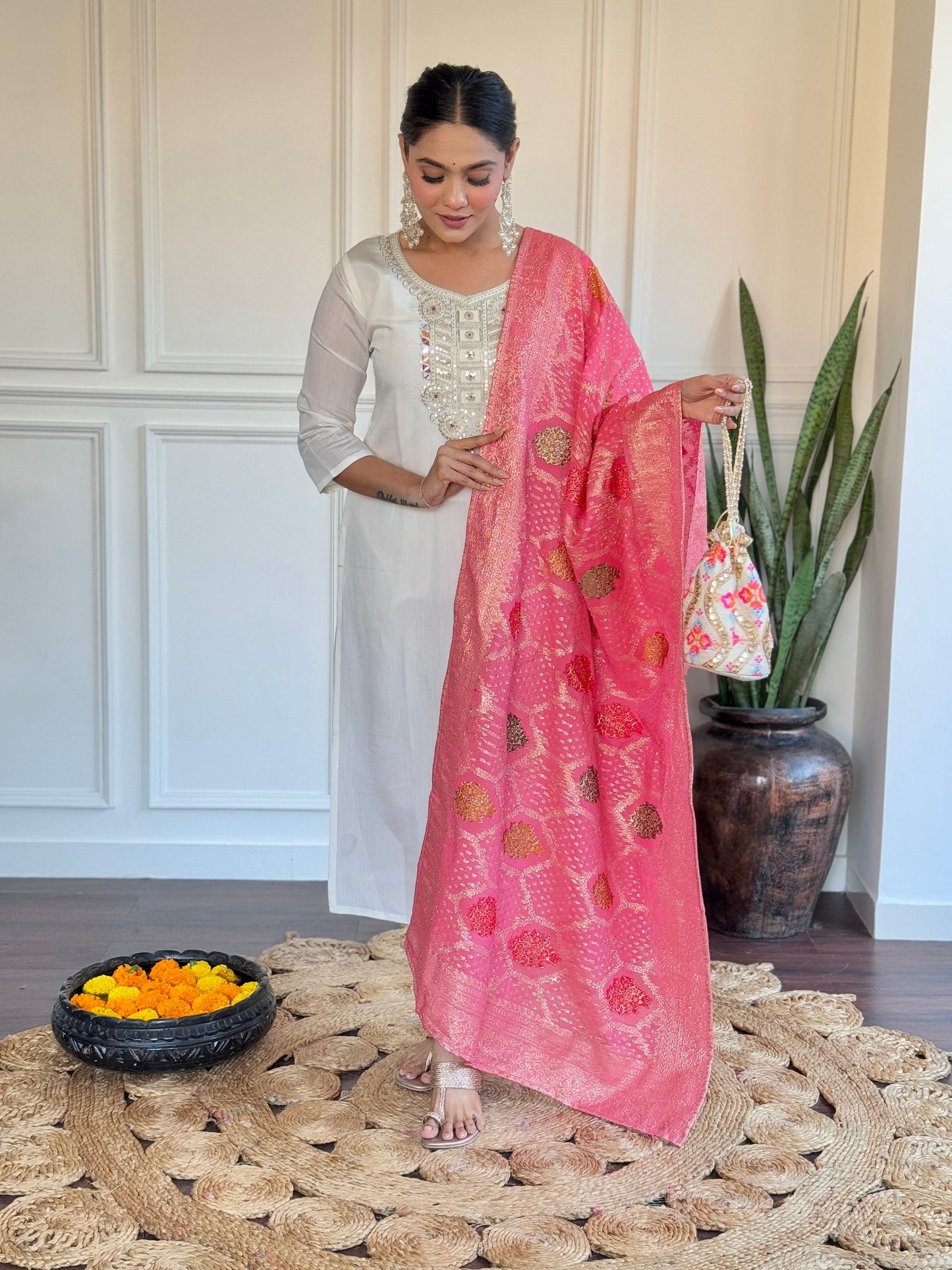 Grace meets tradition in this stunning white kurti set, highlighted with intricate embroidery and a vibrant pink Banarasi dupatta