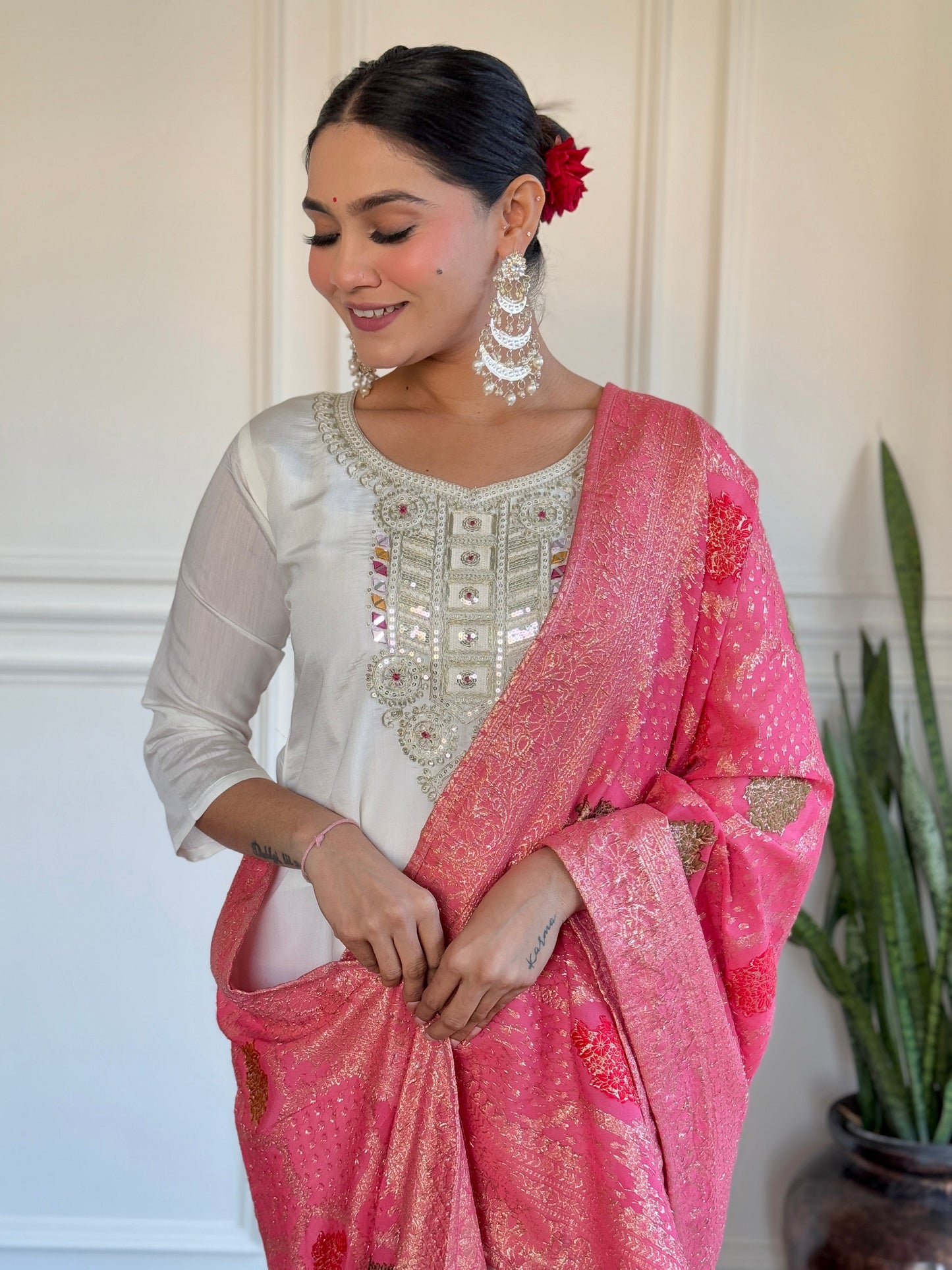Grace meets tradition in this stunning white kurti set, highlighted with intricate embroidery and a vibrant pink Banarasi dupatta