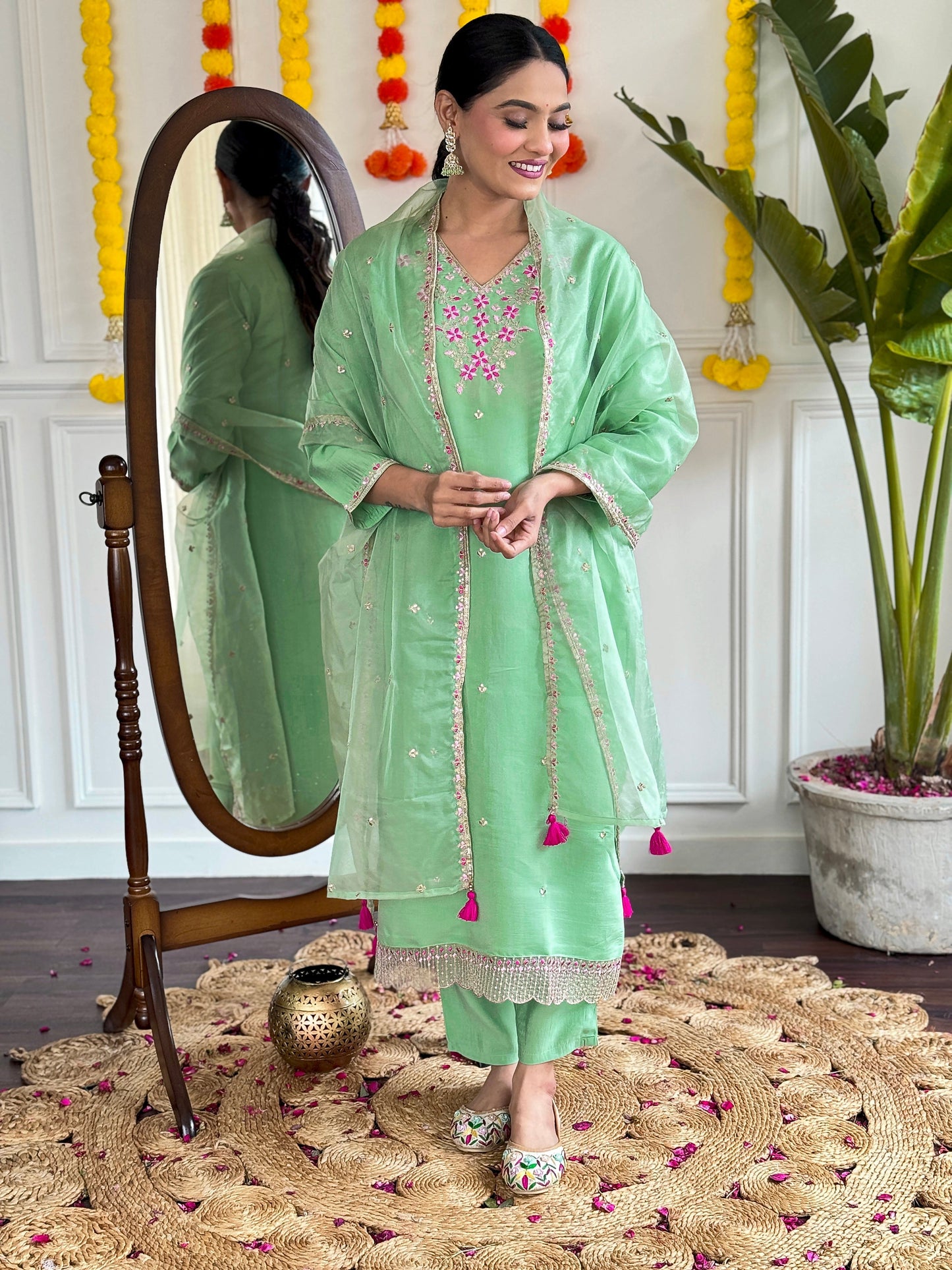Step into elegance with this pastel green kurti set, adorned with delicate pink floral embroidery and shimmering accents