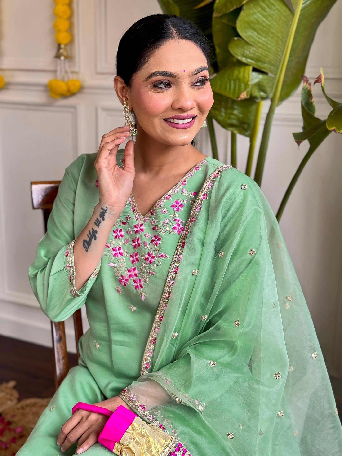 Step into elegance with this pastel green kurti set, adorned with delicate pink floral embroidery and shimmering accents
