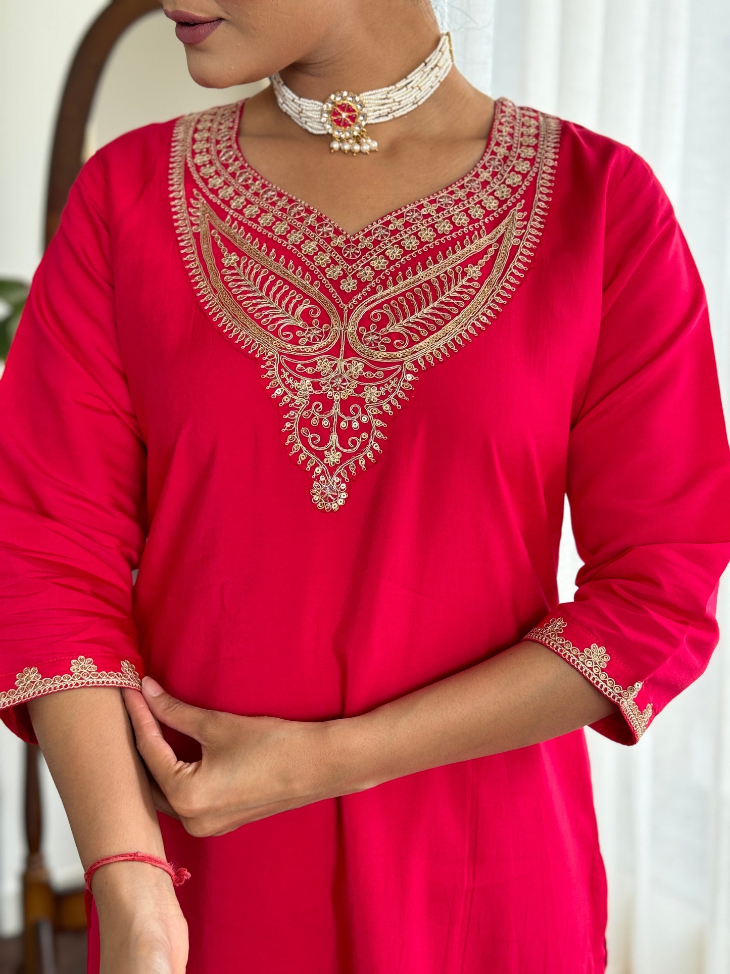 Make a bold statement with this stunning red kurti set, featuring intricate gold embroidery and a luxurious silk dupatta