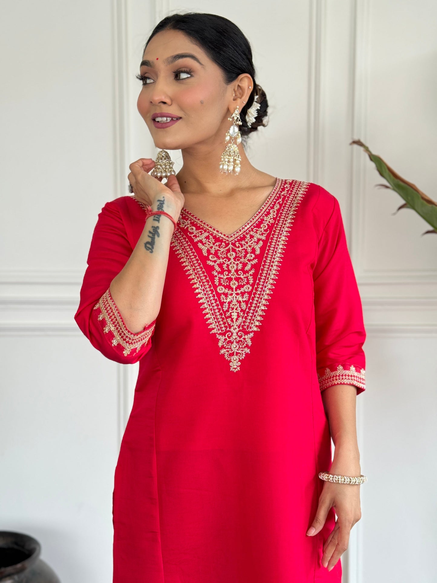 Turn heads in this stunning red kurti set, featuring intricate gold embroidery for a regal touch