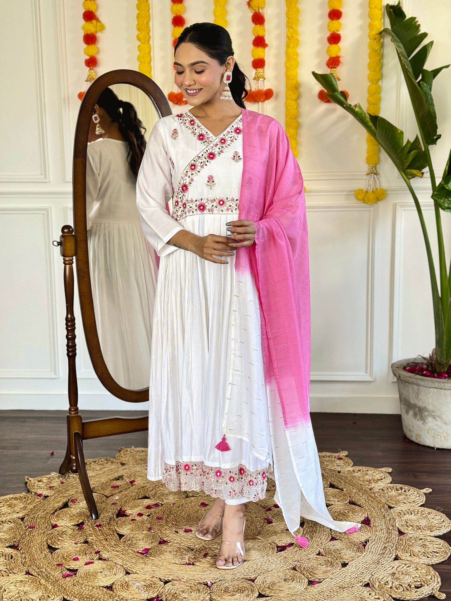 Grace meets elegance in this ethereal white Anarkali set, adorned with delicate floral embroidery and a stunning pink ombre dupatta