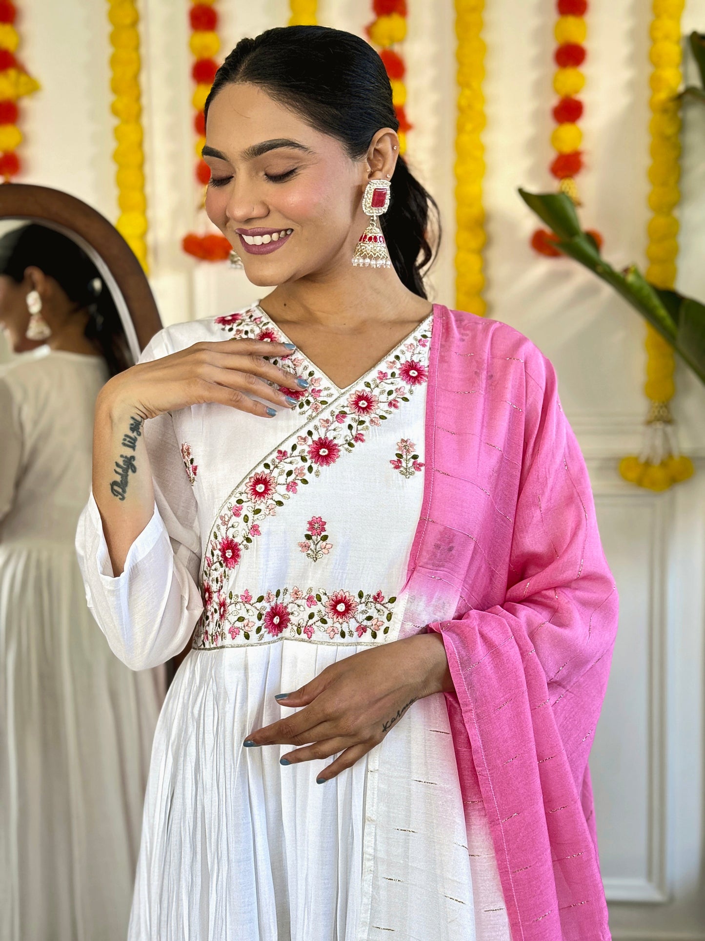 Grace meets elegance in this ethereal white Anarkali set, adorned with delicate floral embroidery and a stunning pink ombre dupatta