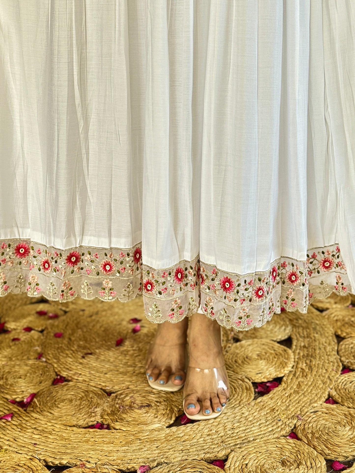 Grace meets elegance in this ethereal white Anarkali set, adorned with delicate floral embroidery and a stunning pink ombre dupatta