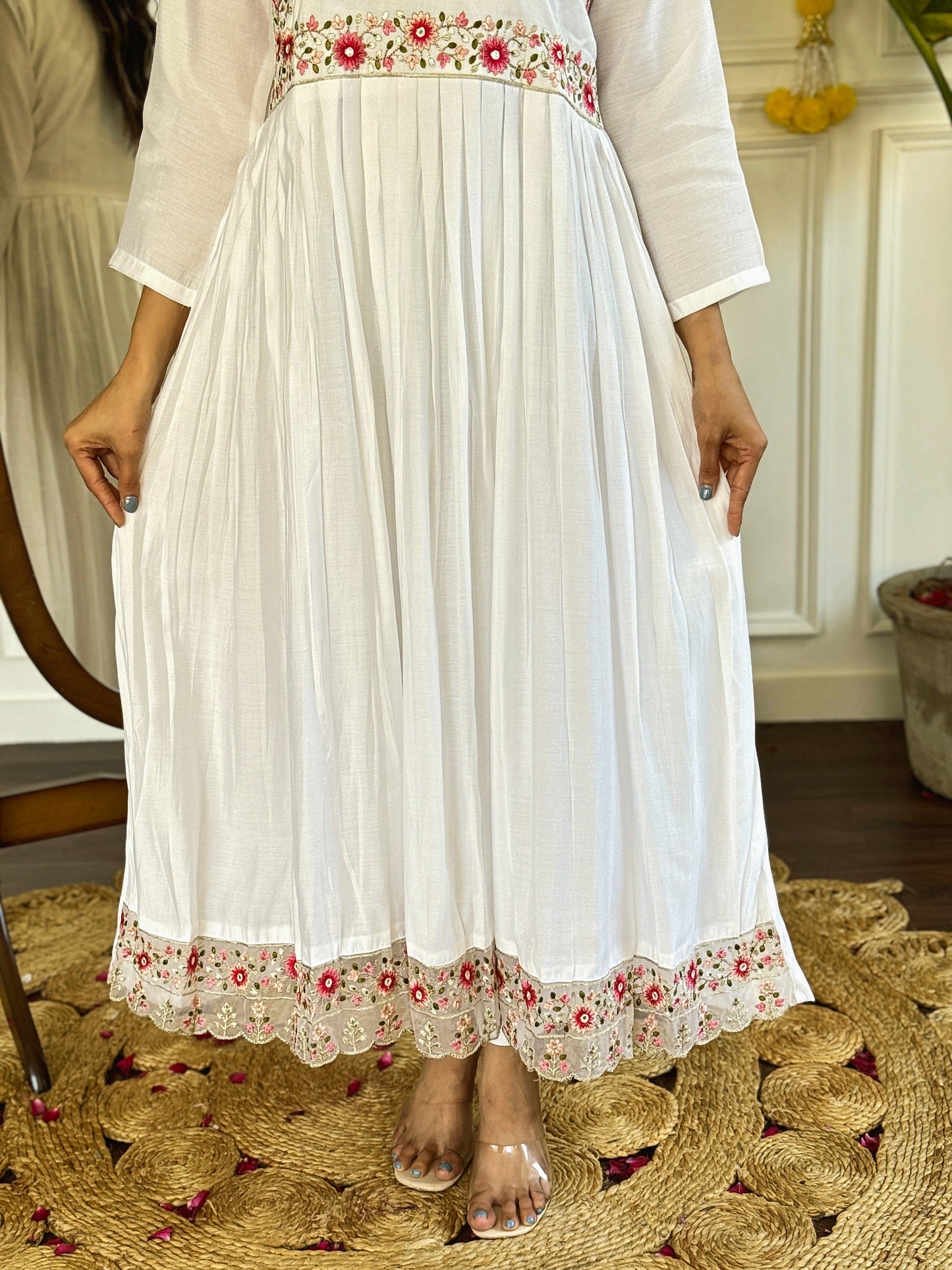 Grace meets elegance in this ethereal white Anarkali set, adorned with delicate floral embroidery and a stunning pink ombre dupatta