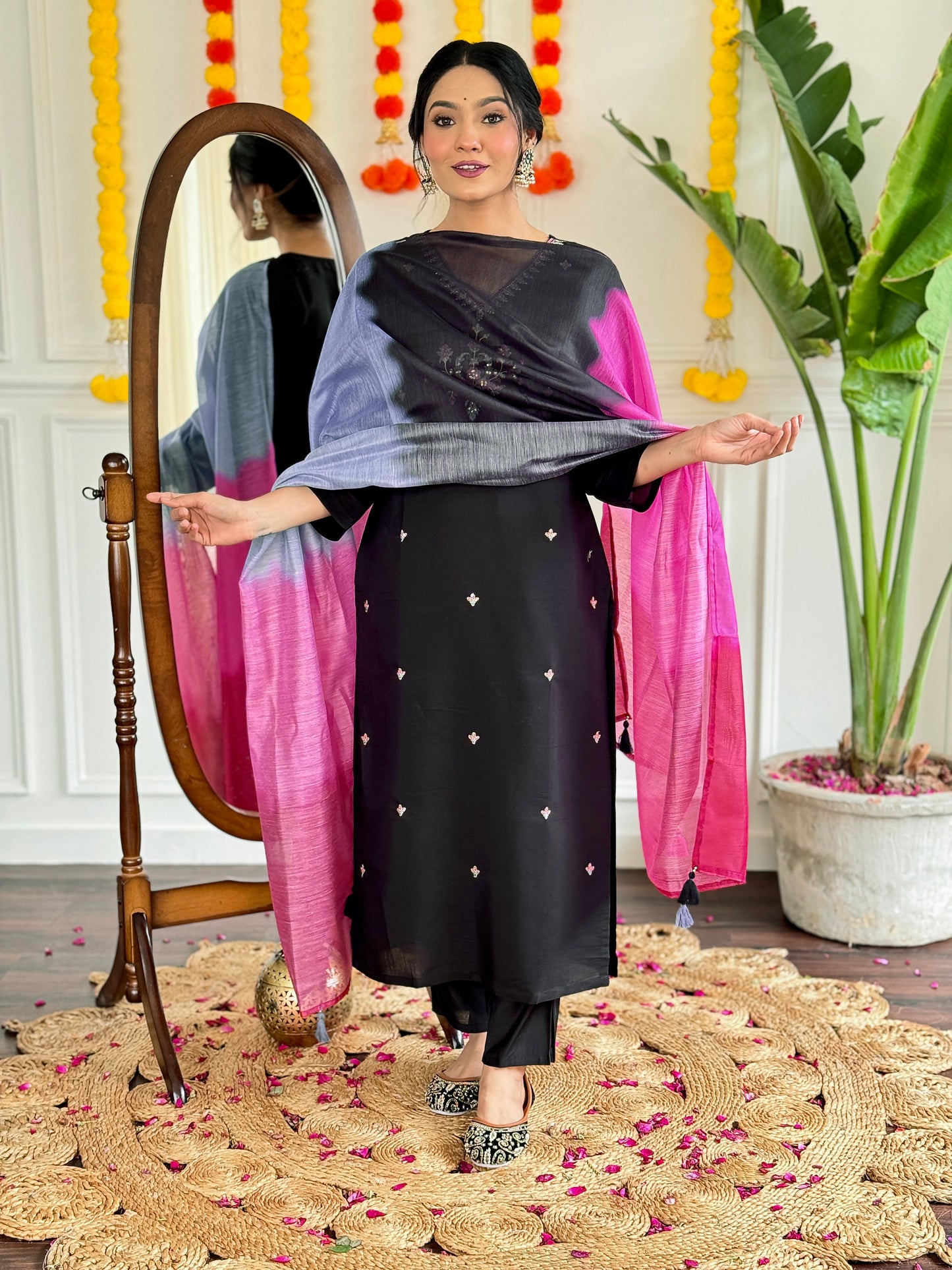 Make a bold statement with this stunning black kurti set, featuring intricate embroidery and a striking ombre dupatta in shades of pink and grey