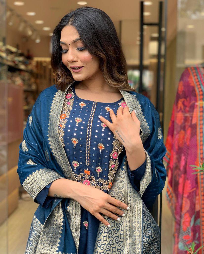 Make a statement with this stunning navy blue kurti set, featuring intricate embroidery and a gracefully adorned dupatta