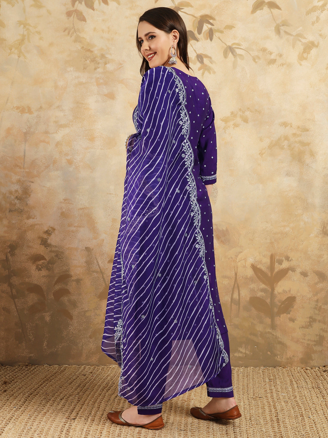 Embrace elegance with this regal purple kurti set, adorned with intricate embroidery and paired with a beautifully striped and embroidered dupatta
