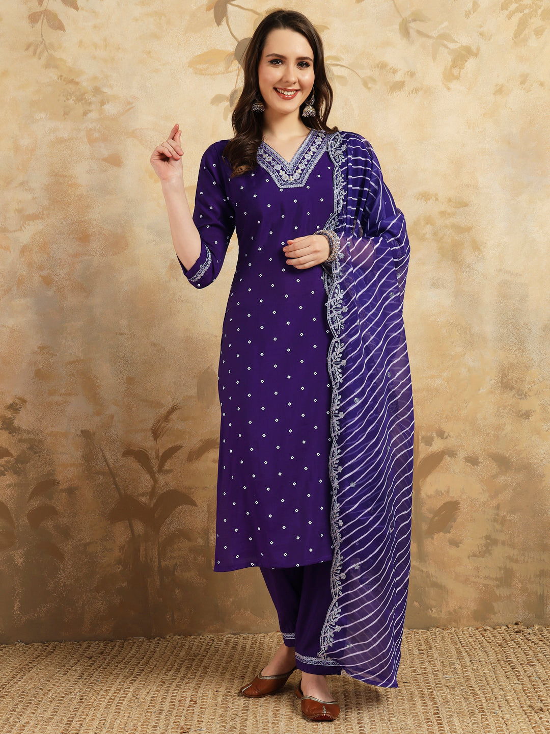 Embrace elegance with this regal purple kurti set, adorned with intricate embroidery and paired with a beautifully striped and embroidered dupatta