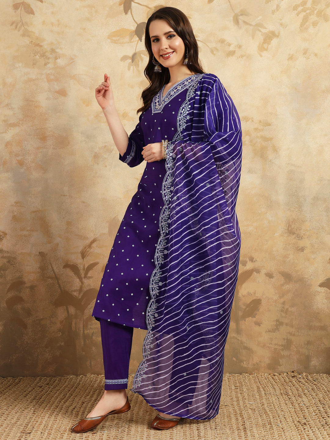 Embrace elegance with this regal purple kurti set, adorned with intricate embroidery and paired with a beautifully striped and embroidered dupatta