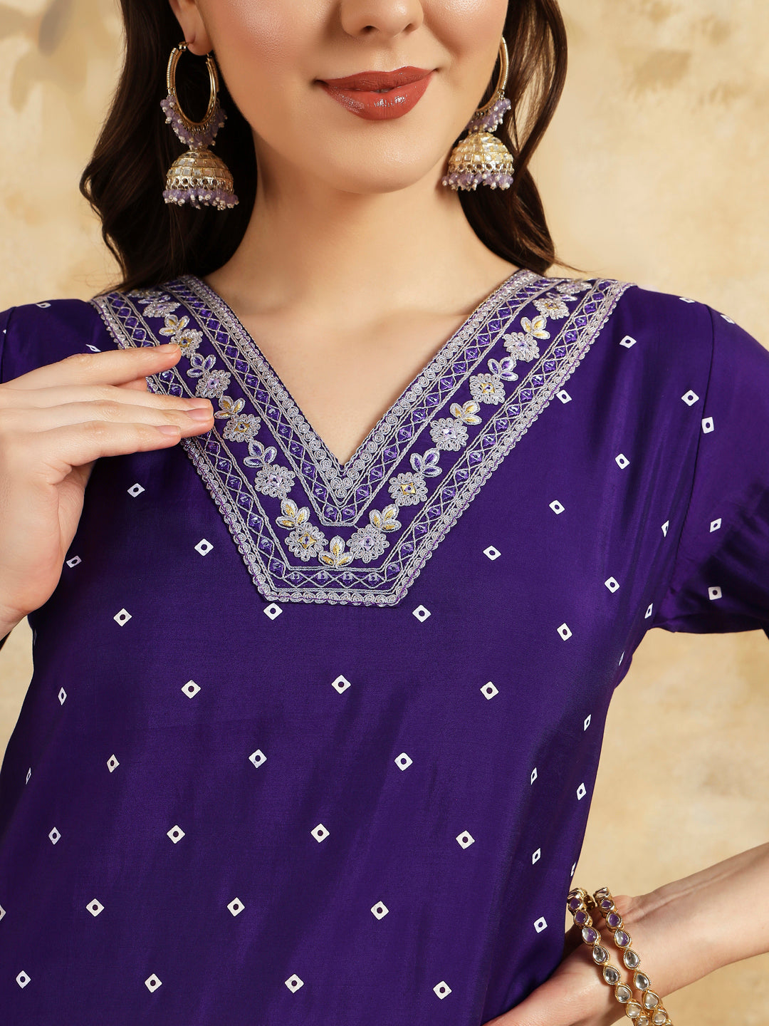 Embrace elegance with this regal purple kurti set, adorned with intricate embroidery and paired with a beautifully striped and embroidered dupatta