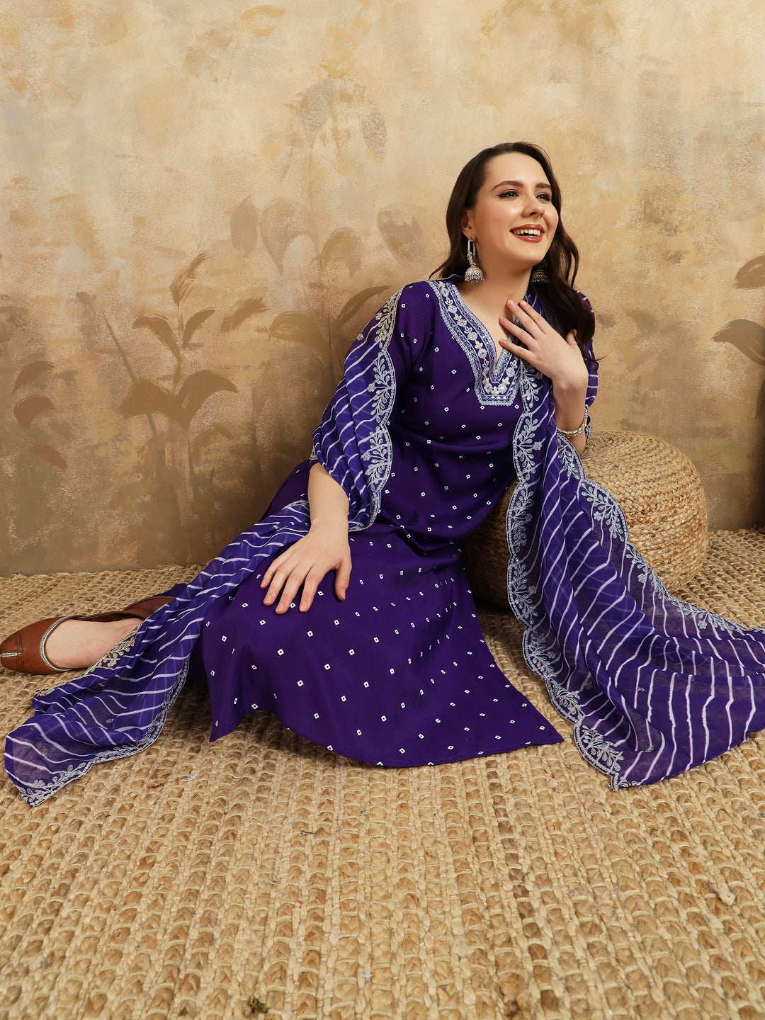 Embrace elegance with this regal purple kurti set, adorned with intricate embroidery and paired with a beautifully striped and embroidered dupatta