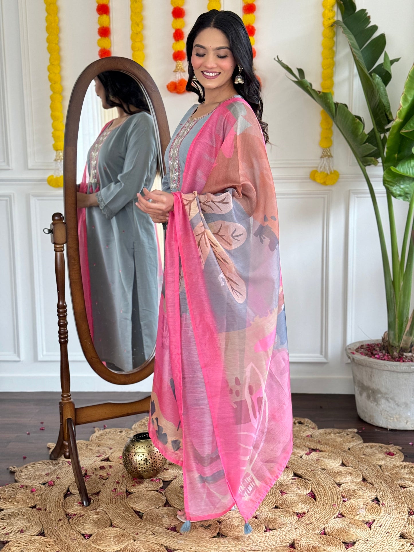 Elevate your style with this elegant grey kurti set, adorned with delicate embroidery and a vibrant pink dupatta