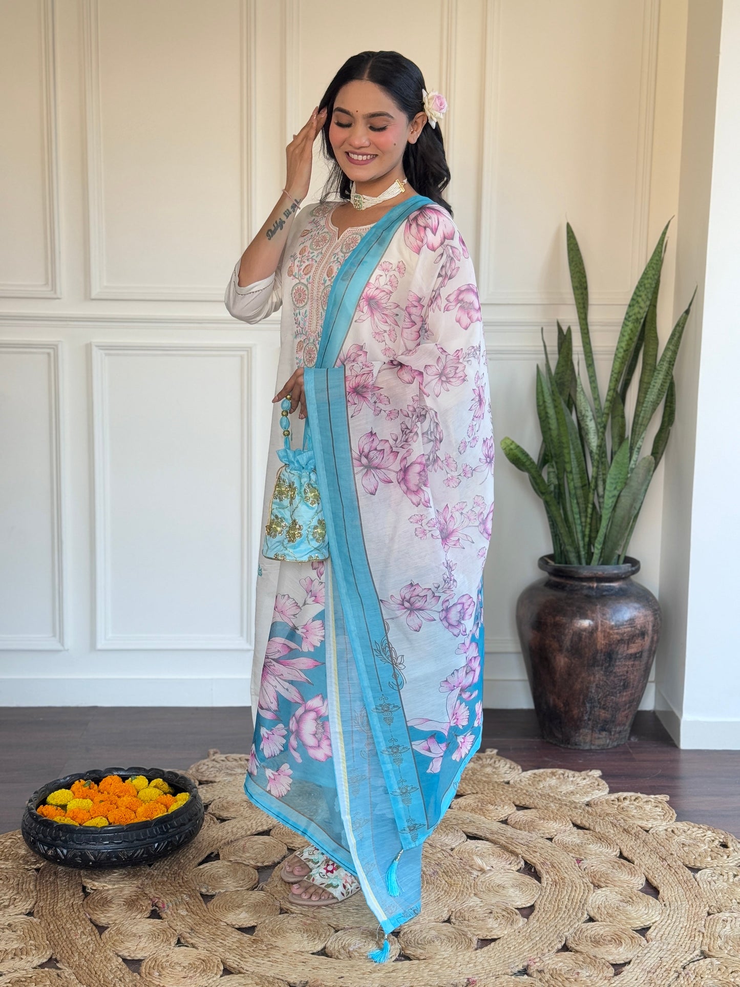 Embrace elegance with this serene white kurti set, adorned with delicate pastel embroidery and a floral-printed blue dupatta
