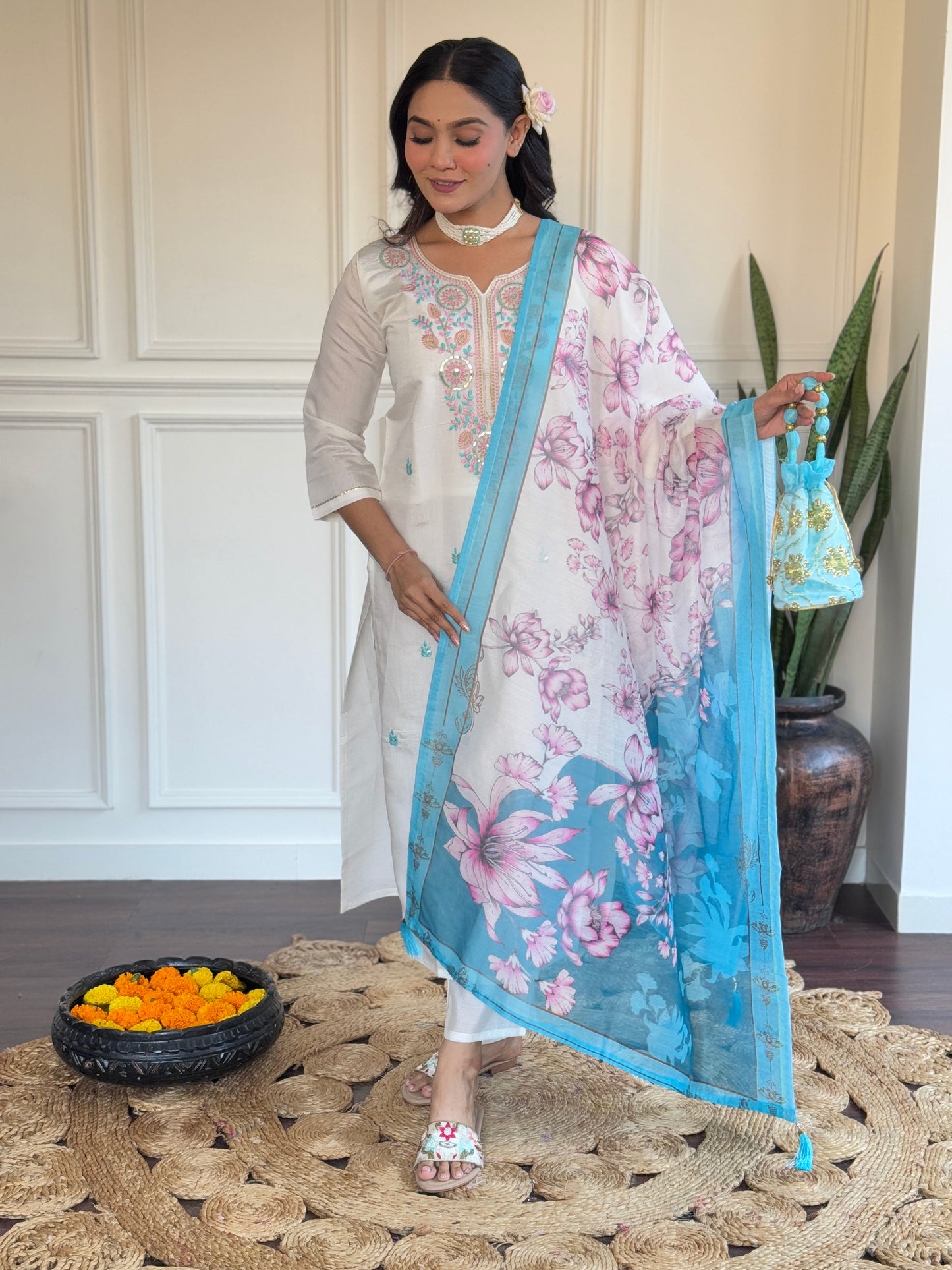 Embrace elegance with this serene white kurti set, adorned with delicate pastel embroidery and a floral-printed blue dupatta