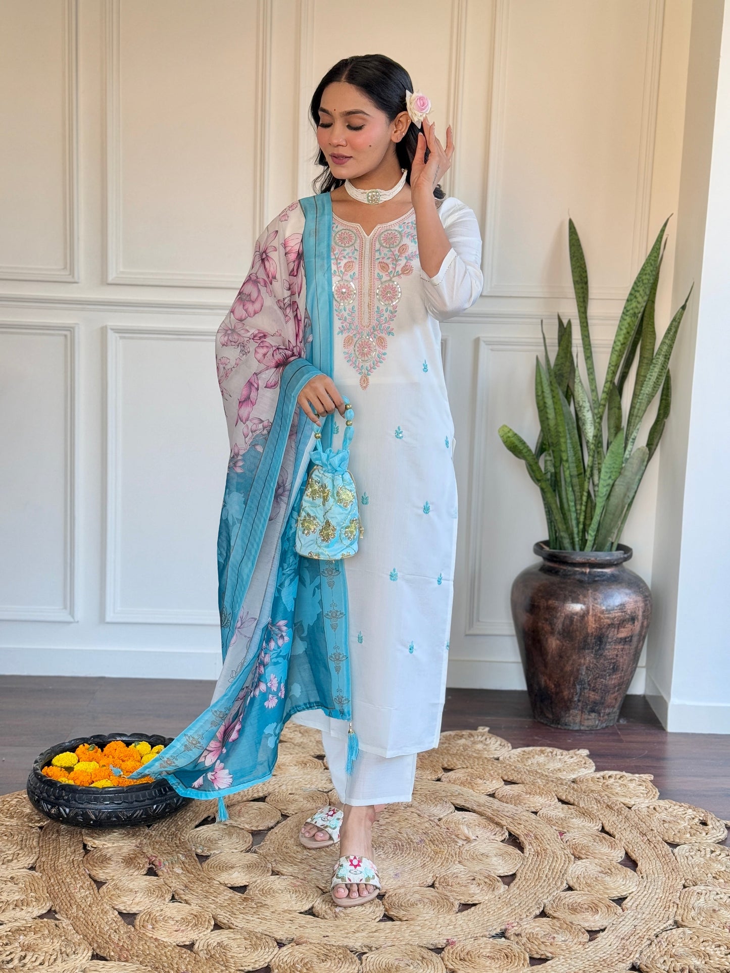 Embrace elegance with this serene white kurti set, adorned with delicate pastel embroidery and a floral-printed blue dupatta