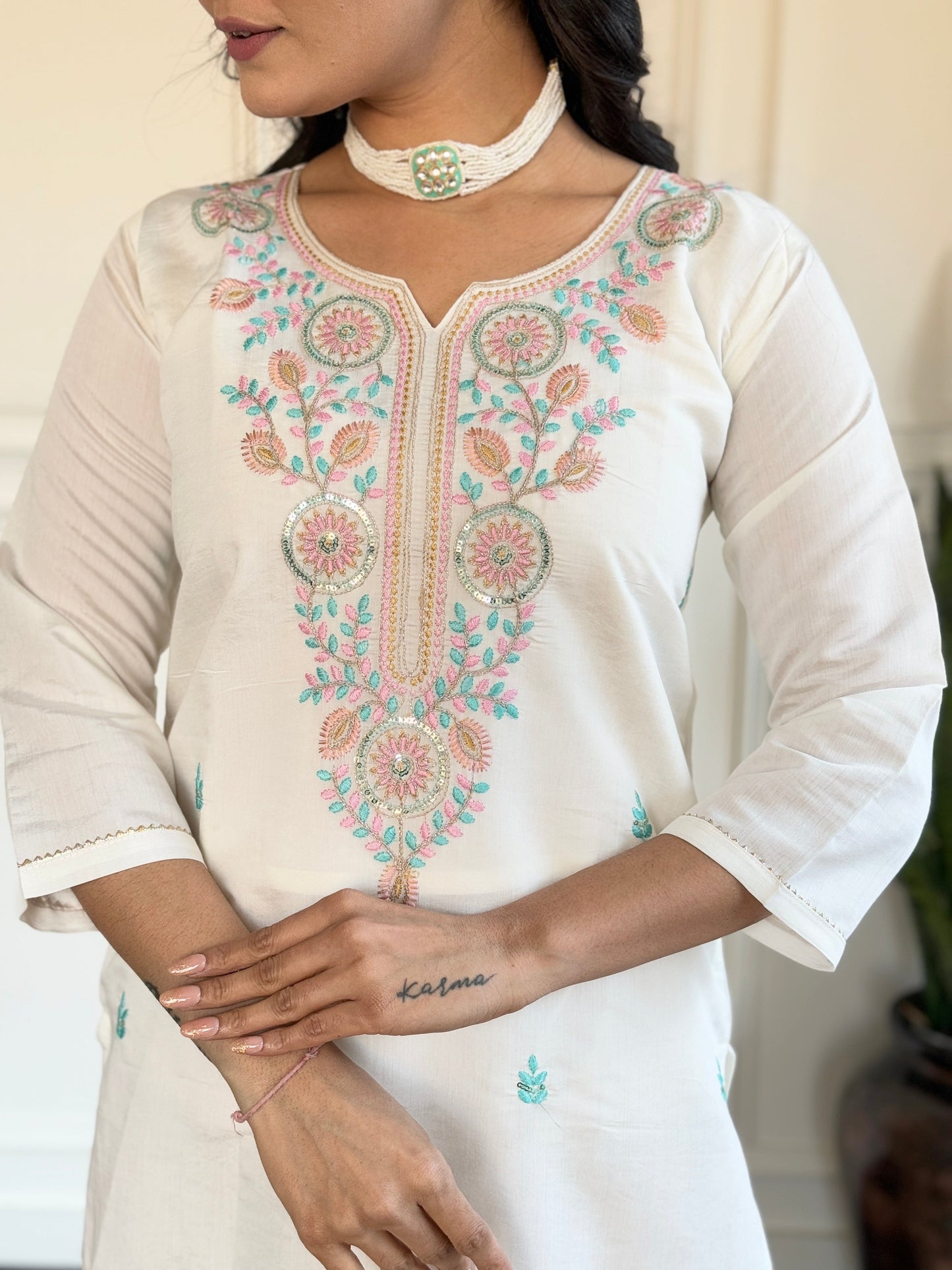 Embrace elegance with this serene white kurti set, adorned with delicate pastel embroidery and a floral-printed blue dupatta
