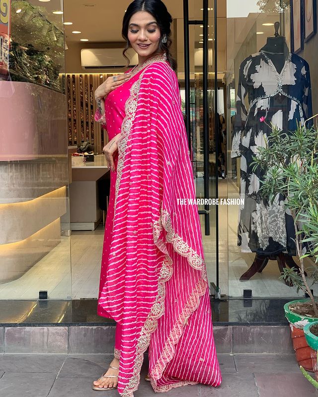 Step into timeless elegance with this vibrant pink kurti set, featuring intricate mirror work and a stunning bandhani dupatta
