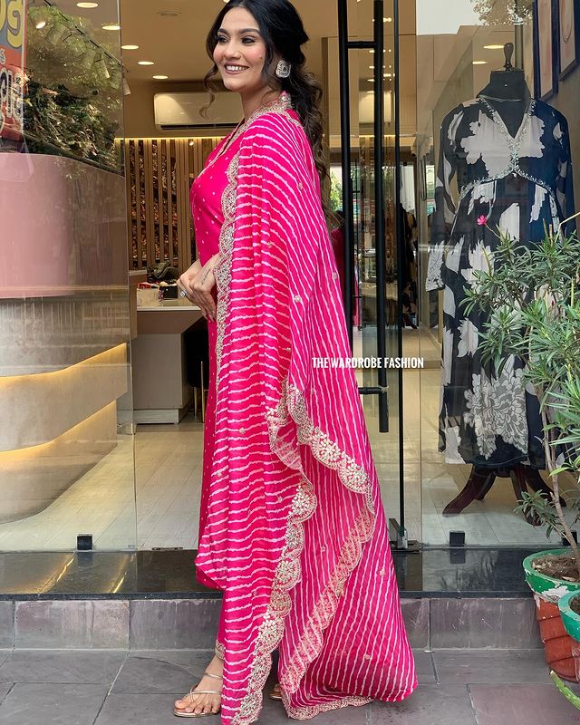 Step into timeless elegance with this vibrant pink kurti set, featuring intricate mirror work and a stunning bandhani dupatta