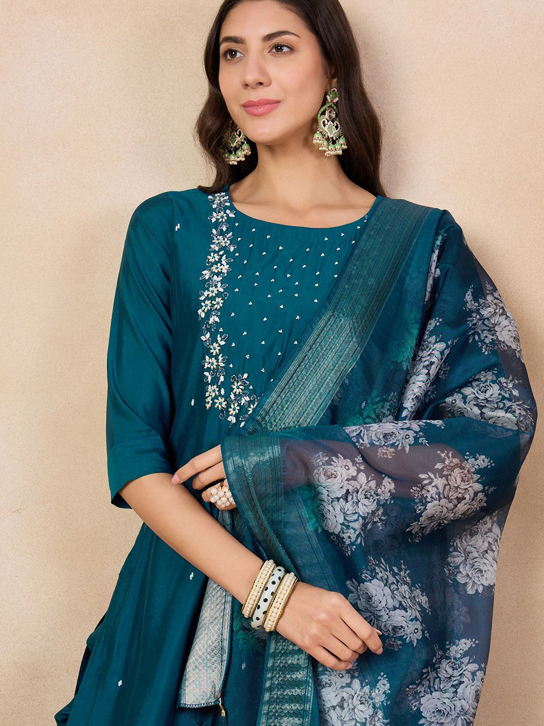 Step into elegance with this teal blue kurti set, adorned with intricate embroidery and a beautifully printed dupatta. The rich color and delicate detailing make it a perfect choice for festive occasions and gatherings.