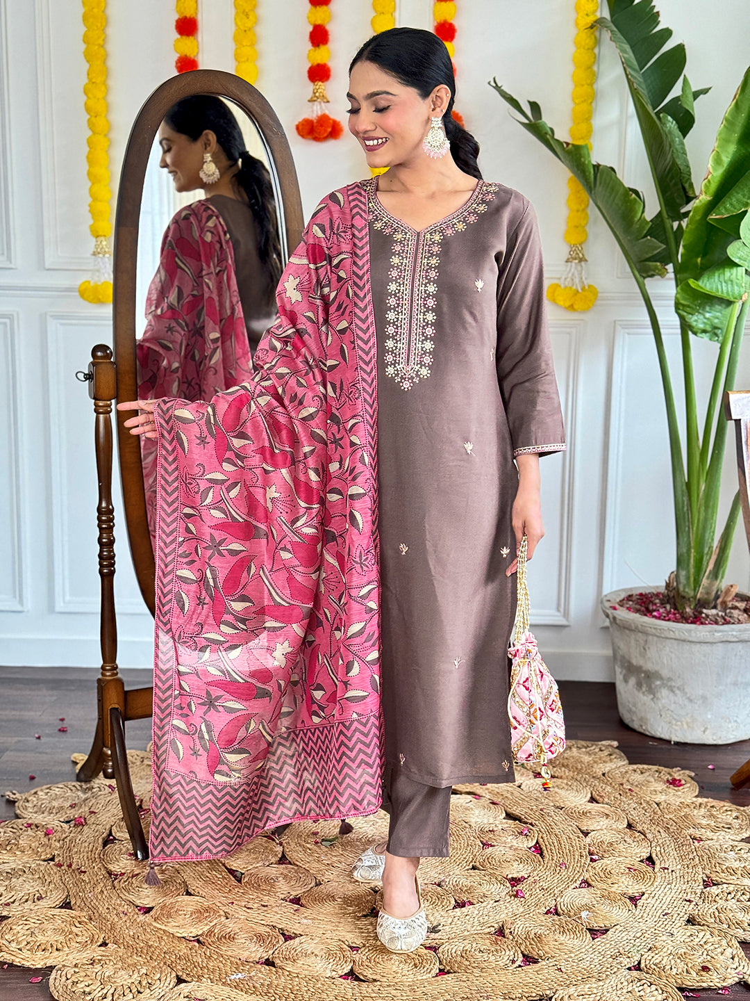 This elegant brown kurti set is a perfect blend of simplicity and sophistication. Featuring delicate embroidery on the neckline and a contrasting pink floral dupatta