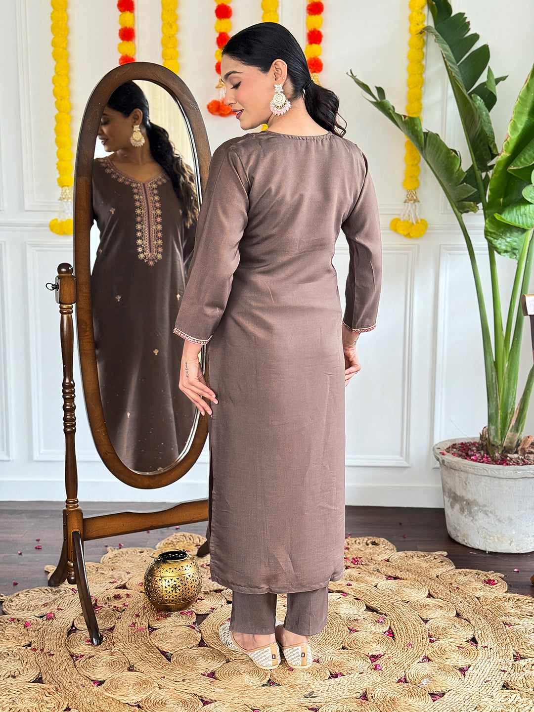 This elegant brown kurti set is a perfect blend of simplicity and sophistication. Featuring delicate embroidery on the neckline and a contrasting pink floral dupatta
