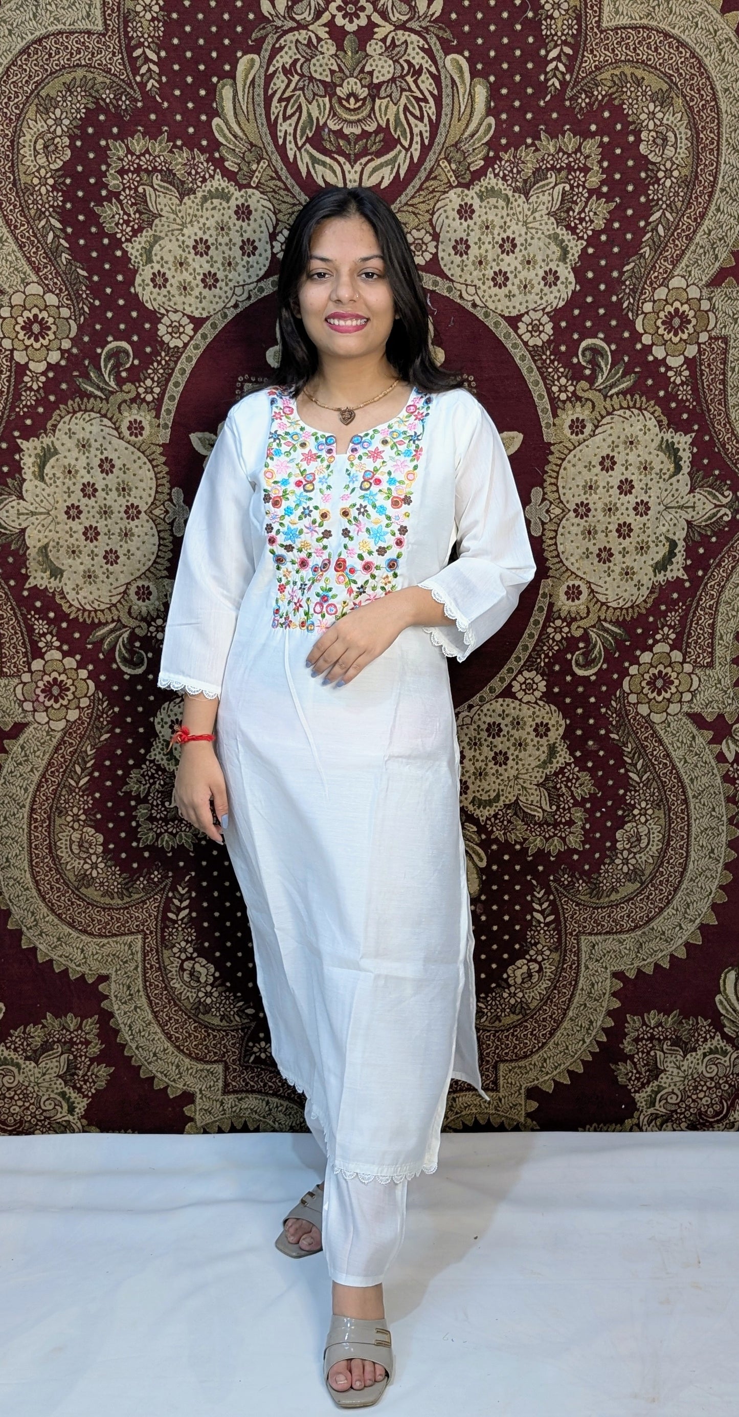 Elevate your elegance with this pristine white kurti set, featuring exquisite multicolor embroidery on the neckline