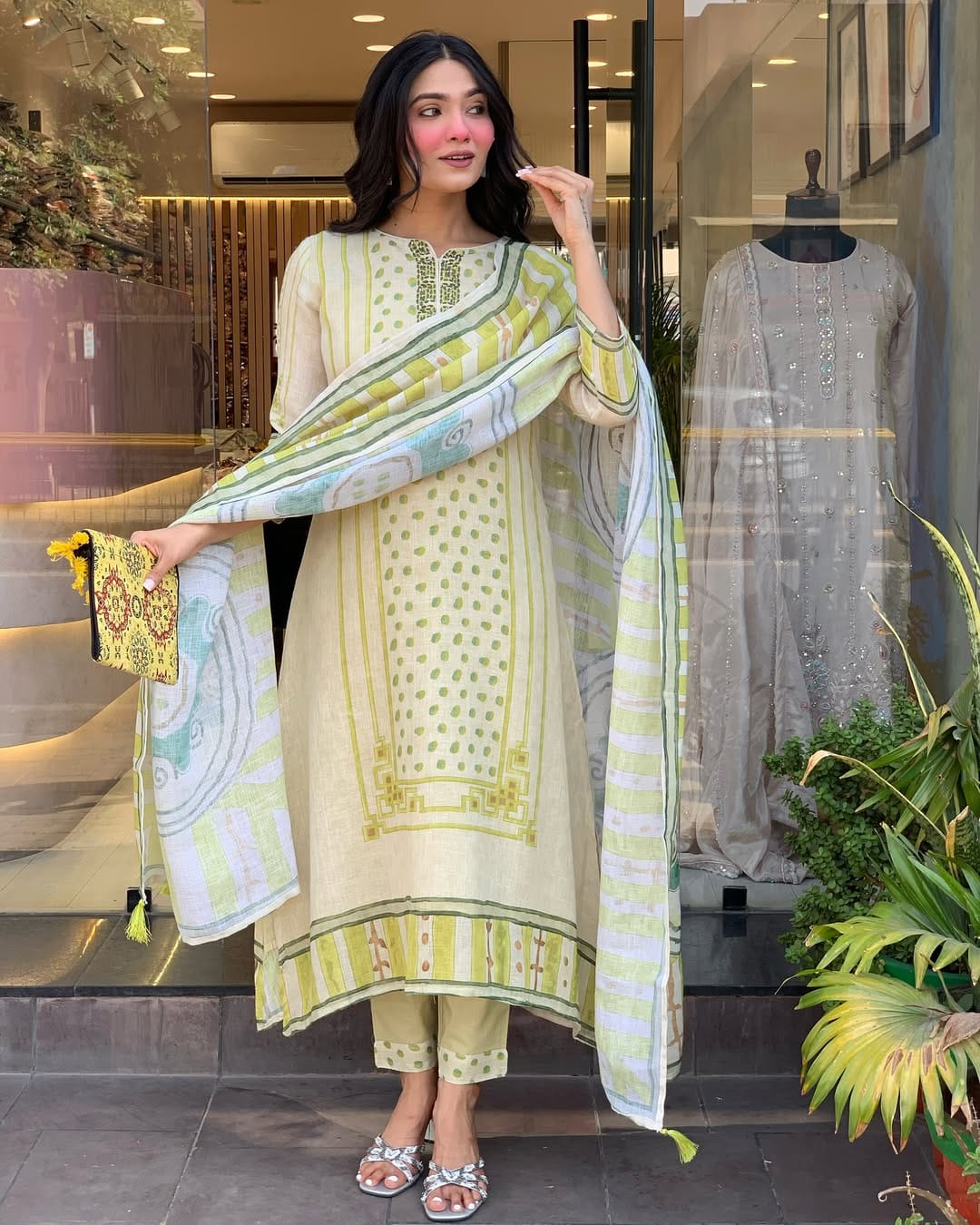 Brighten your wardrobe with this charming pastel green kurti set featuring playful polka dot prints and fine embroidery. Paired with a striped dupatta and matching pants, it's perfect for a light, breezy, and elegant daytime look.