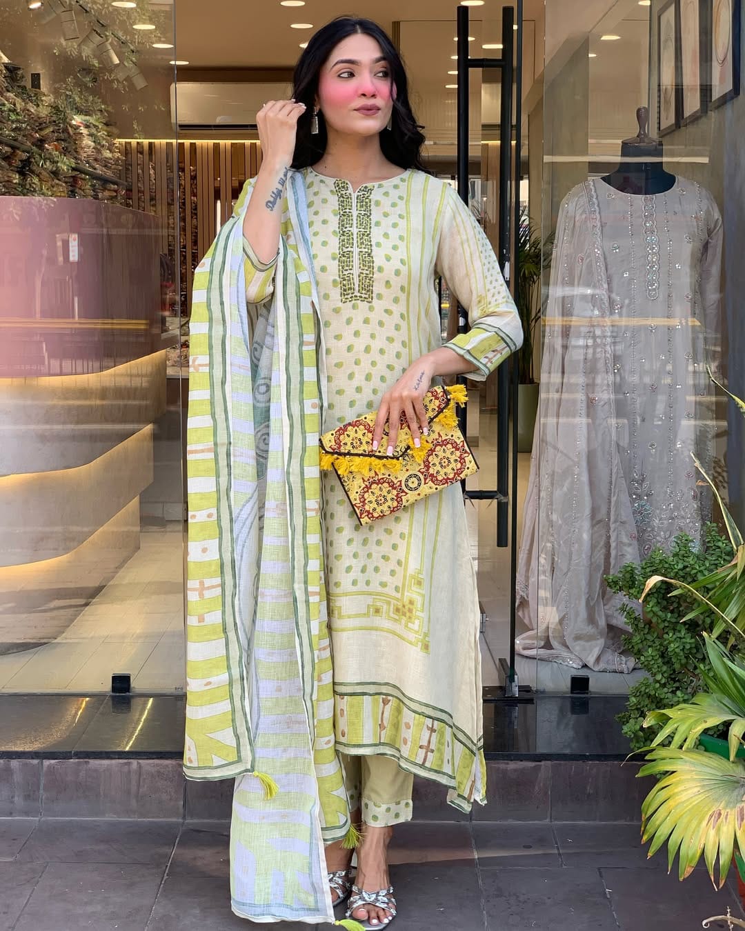Brighten your wardrobe with this charming pastel green kurti set featuring playful polka dot prints and fine embroidery. Paired with a striped dupatta and matching pants, it's perfect for a light, breezy, and elegant daytime look.